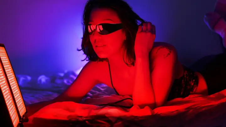 Woman using FAQ Collection dual red light panel